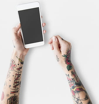Free hand with tattoos using mobile phone mockup psd vector